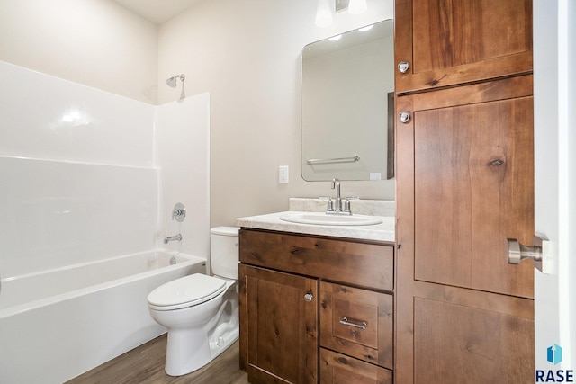 full bathroom featuring vanity, hardwood / wood-style flooring, shower / tub combination, and toilet