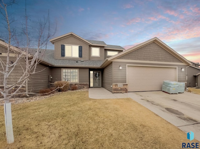 view of front of house featuring a garage and a yard