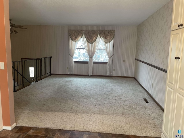 empty room featuring dark carpet