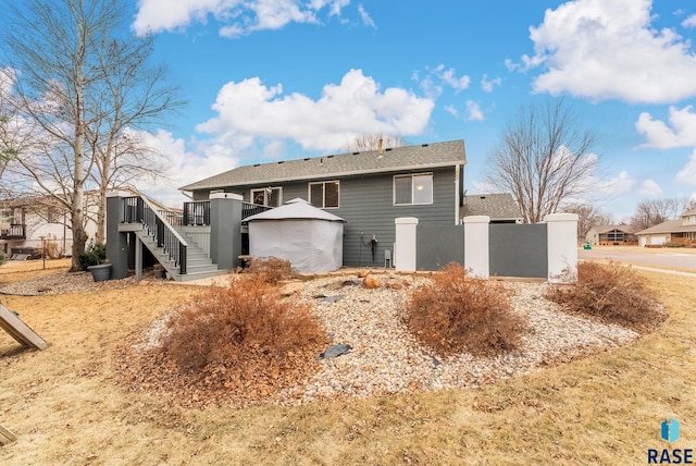 back of property featuring a gazebo