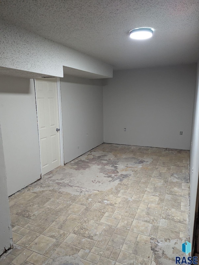 basement featuring a textured ceiling