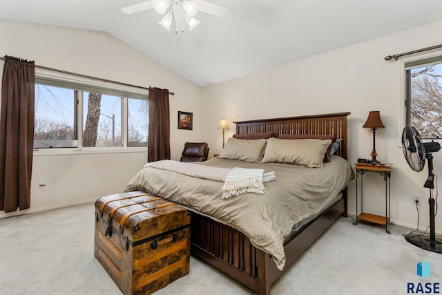 carpeted bedroom with ceiling fan and vaulted ceiling