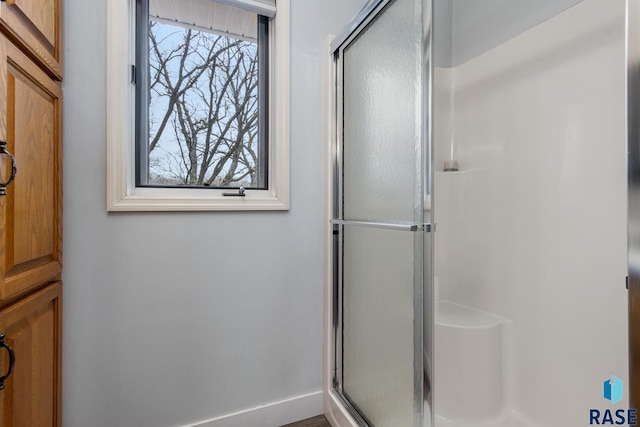 bathroom with a healthy amount of sunlight and an enclosed shower