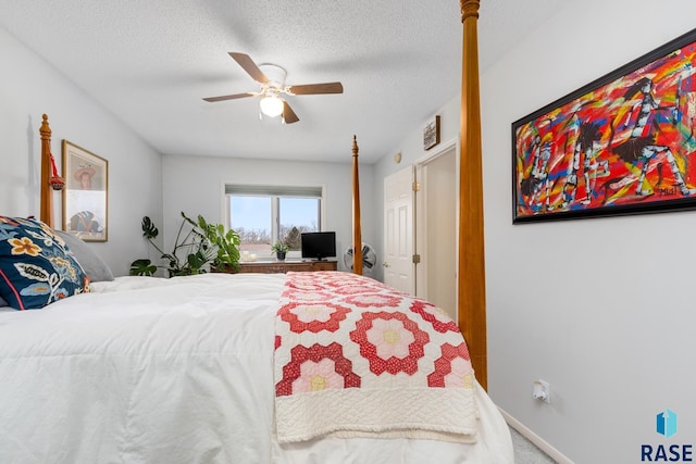 carpeted bedroom with a textured ceiling and ceiling fan