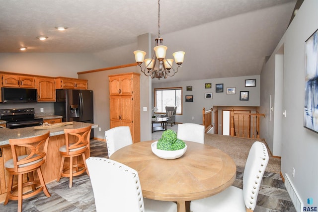 dining area featuring a chandelier and lofted ceiling