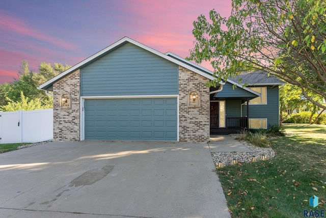 view of front facade with a garage and a yard