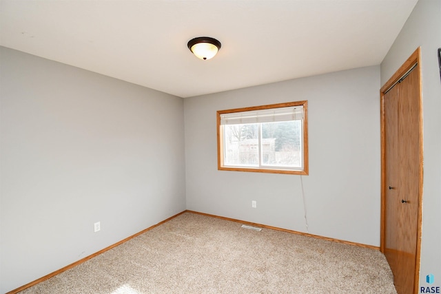 unfurnished bedroom featuring carpet flooring and a closet