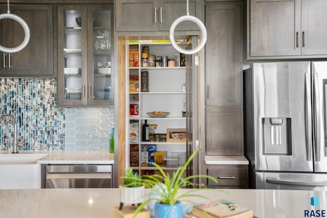 kitchen with decorative backsplash, sink, dark brown cabinetry, and stainless steel appliances