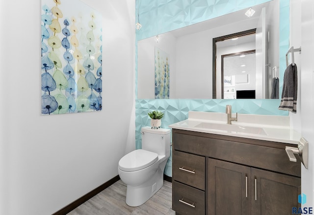 bathroom featuring vanity, toilet, decorative backsplash, and wood-type flooring