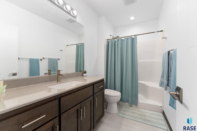 full bathroom with toilet, vanity, and shower / tub combo with curtain