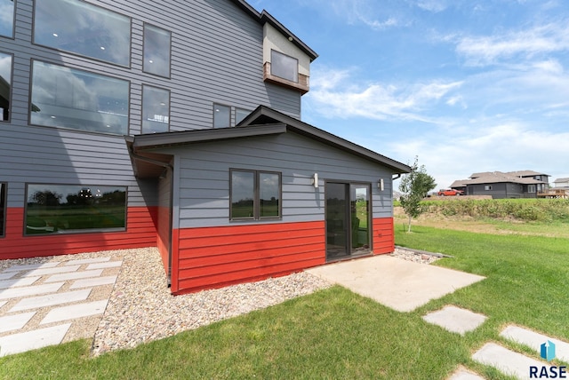 rear view of house with a yard