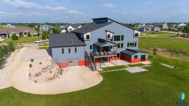 back of property with a garage, a wooden deck, and a yard