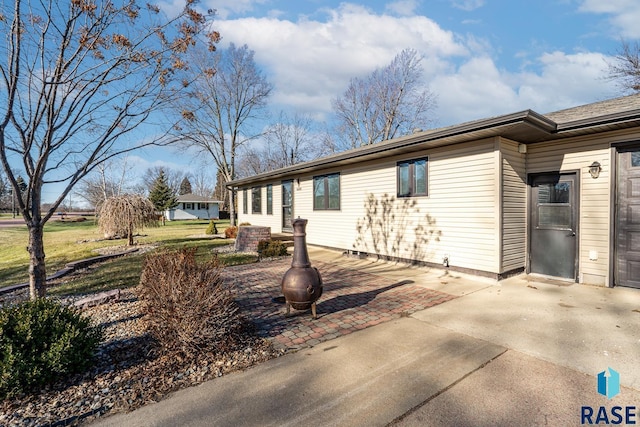 view of property exterior with a patio area