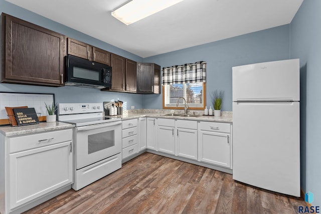 kitchen with white appliances, dark brown cabinetry, white cabinetry, dark hardwood / wood-style flooring, and sink