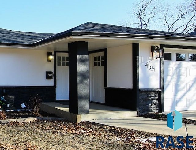 doorway to property with a garage