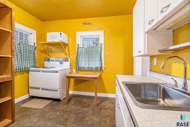 kitchen with sink, white appliances, and white cabinets