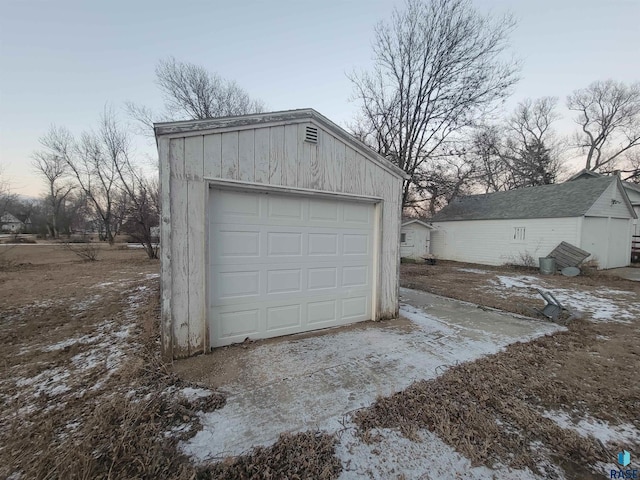 view of garage at dusk