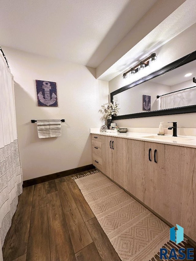 bathroom featuring vanity and wood-type flooring