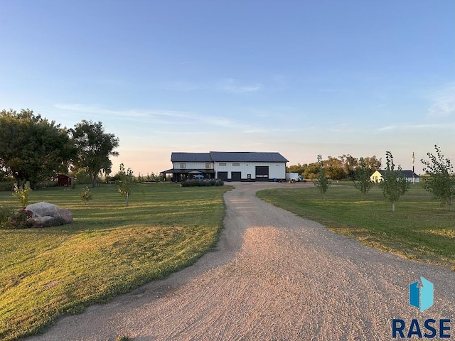 manufactured / mobile home with a rural view and a lawn