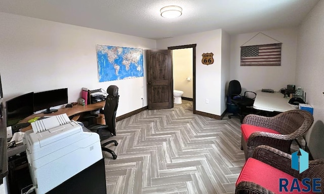 home office featuring a textured ceiling