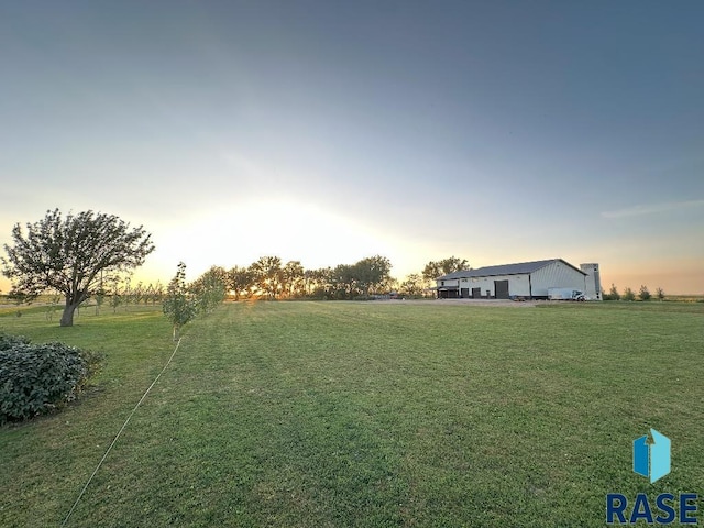 yard at dusk with a rural view