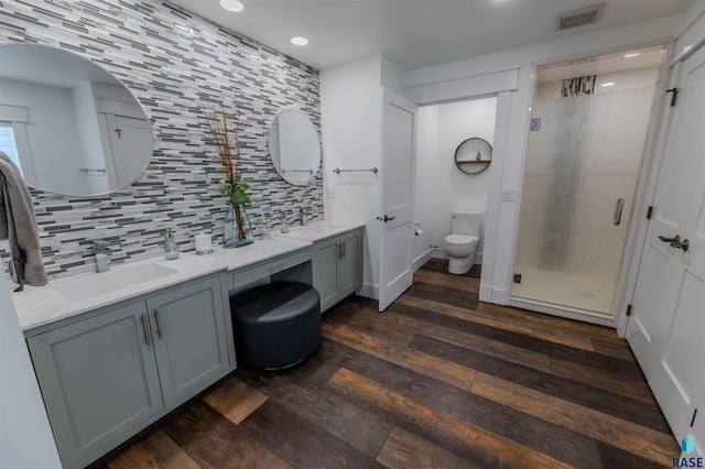 bathroom with toilet, an enclosed shower, vanity, hardwood / wood-style flooring, and decorative backsplash