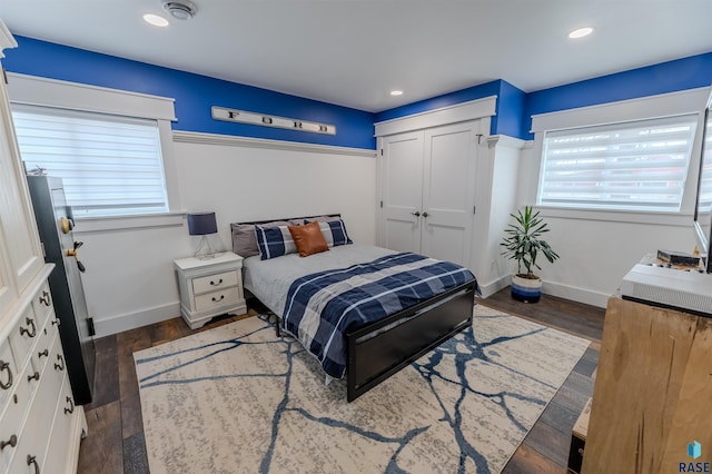 bedroom featuring dark wood-type flooring and a closet