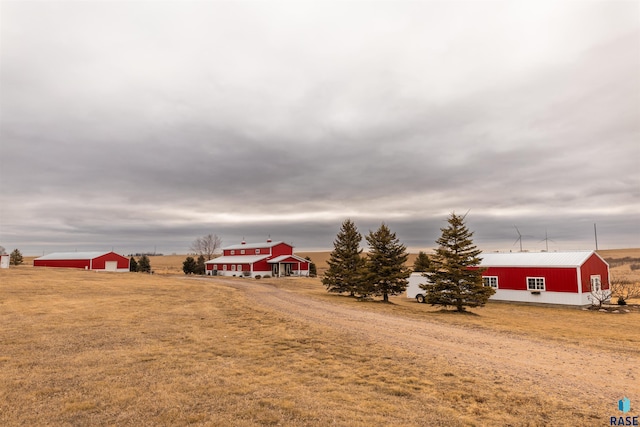 view of yard with a rural view and an outbuilding