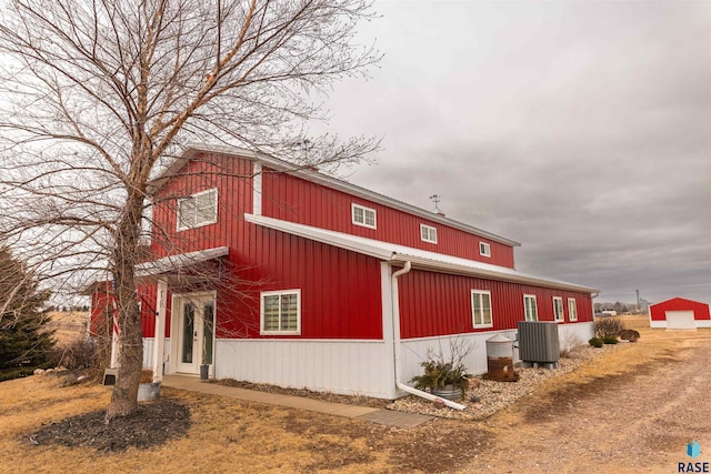 view of side of property featuring an outbuilding and cooling unit