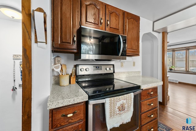 kitchen featuring electric range and light stone counters