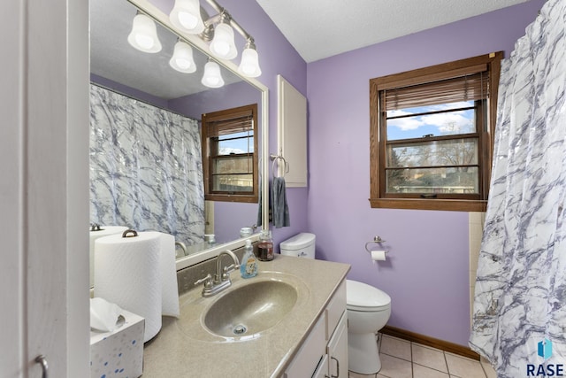 bathroom with vanity, tile patterned floors, a textured ceiling, and toilet