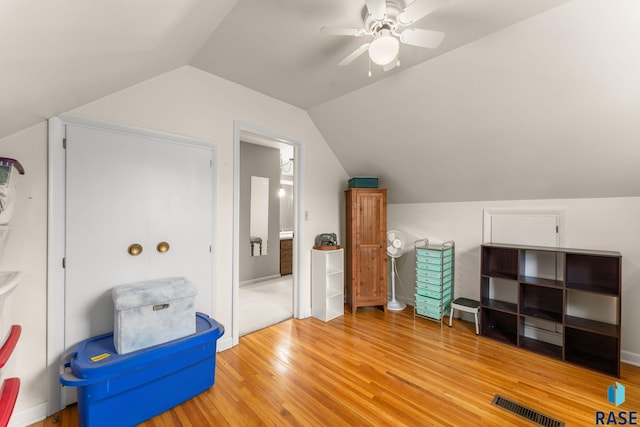 additional living space with lofted ceiling, hardwood / wood-style floors, and ceiling fan