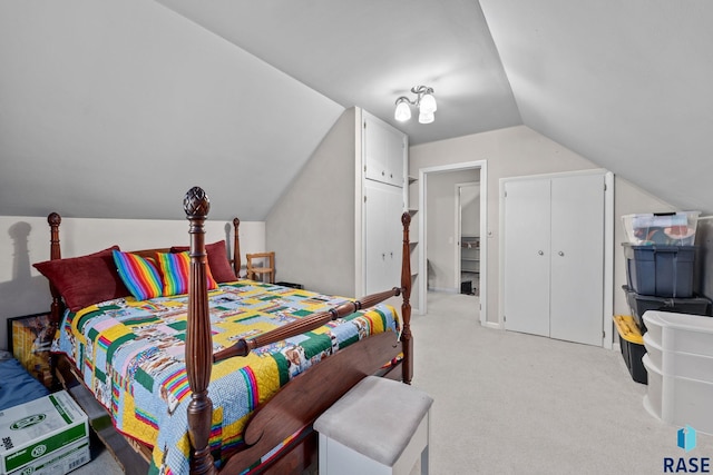 carpeted bedroom with lofted ceiling and a closet