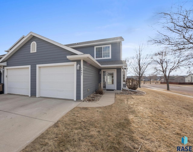 view of front of home with a garage and a front lawn