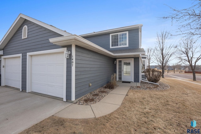 view of front of house with a garage and a front lawn