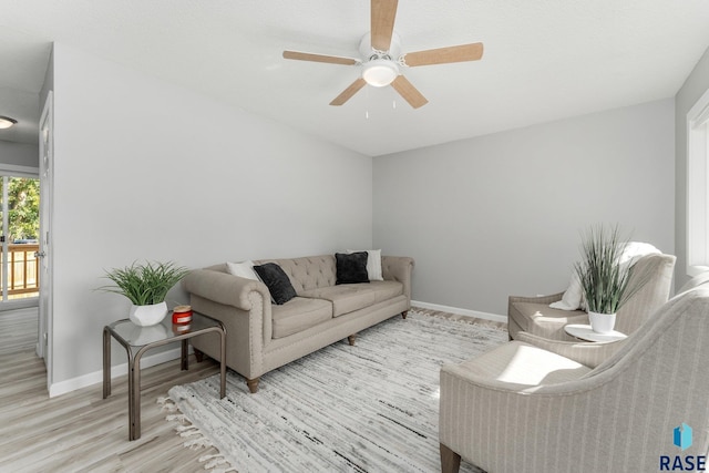 living room with ceiling fan and light wood-type flooring