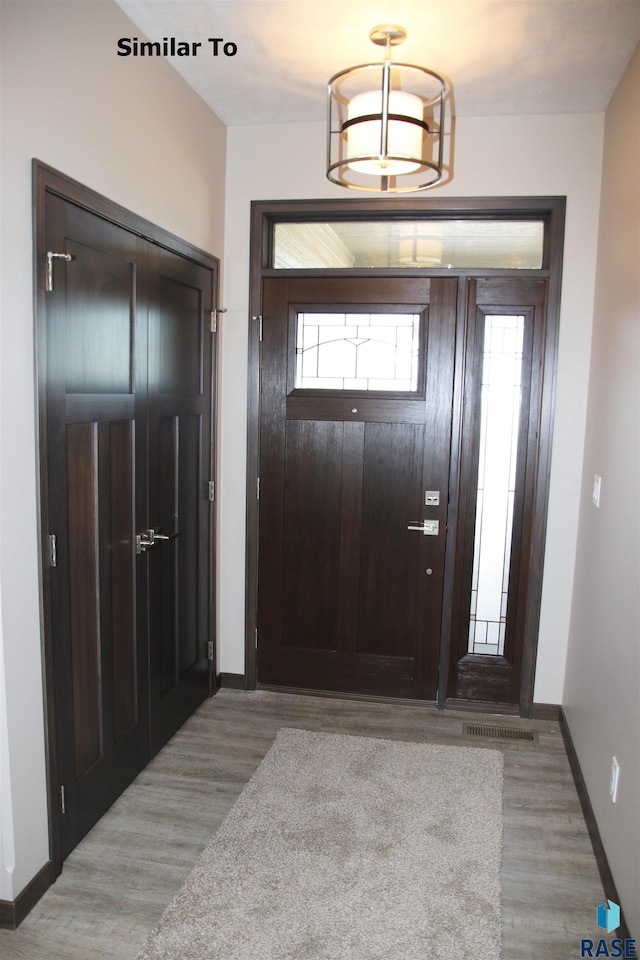 entryway featuring baseboards and light wood finished floors