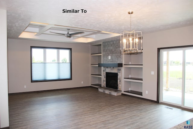 unfurnished living room with visible vents, baseboards, dark wood finished floors, built in shelves, and a fireplace