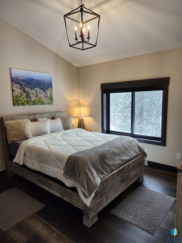 bedroom featuring dark wood-type flooring and an inviting chandelier