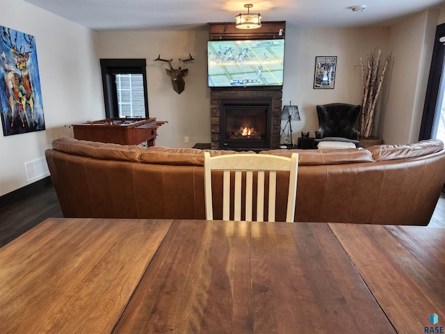 living room featuring hardwood / wood-style floors, a fireplace, and plenty of natural light