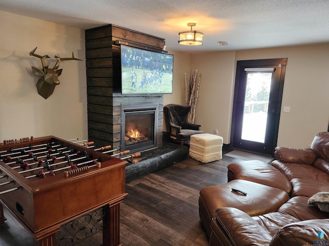 living room with dark hardwood / wood-style floors and a textured ceiling