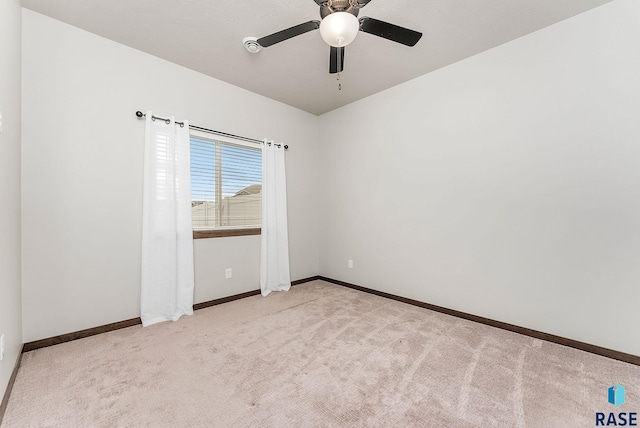 carpeted spare room with ceiling fan