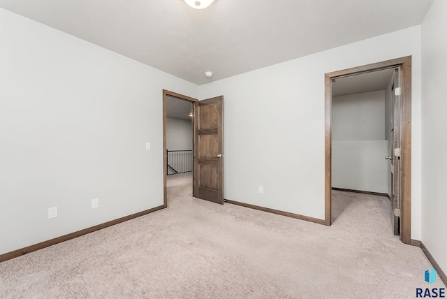 unfurnished bedroom featuring light carpet