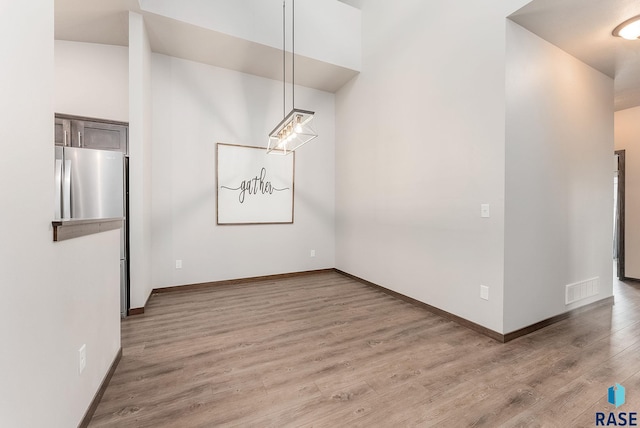 unfurnished dining area featuring hardwood / wood-style flooring