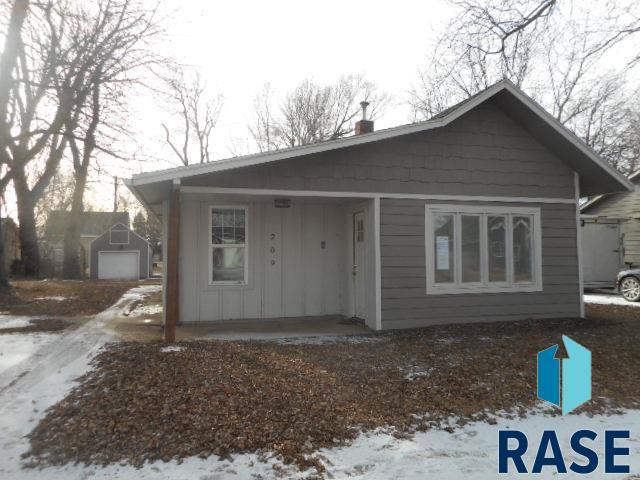 view of front facade featuring a garage and an outdoor structure