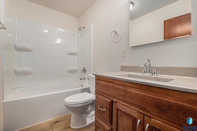 full bathroom with shower / bath combination, vanity, hardwood / wood-style floors, and toilet