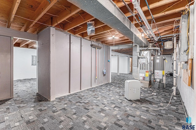 basement featuring heating unit, electric panel, water heater, and dark colored carpet