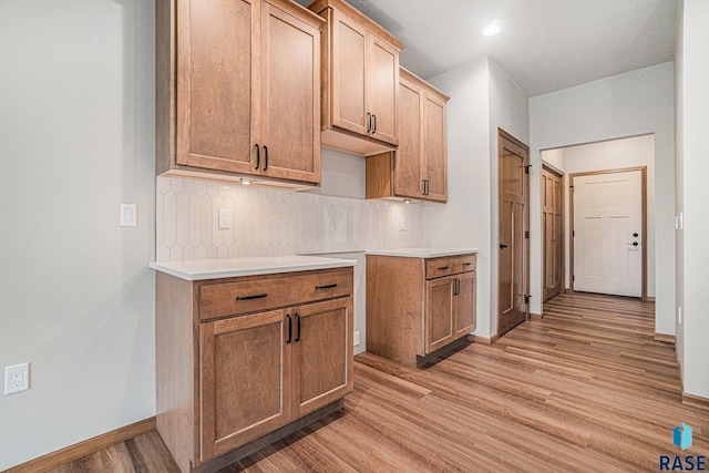 kitchen featuring decorative backsplash and light wood-type flooring