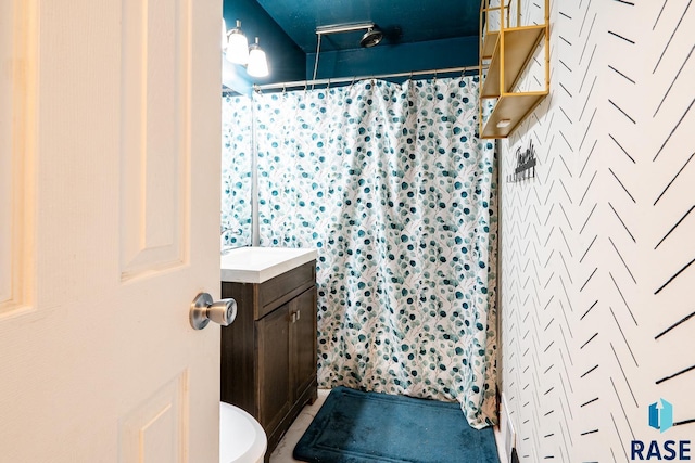 bathroom featuring vanity, toilet, and curtained shower