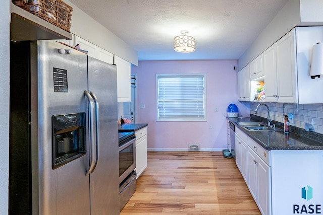 kitchen with white cabinetry, appliances with stainless steel finishes, and sink